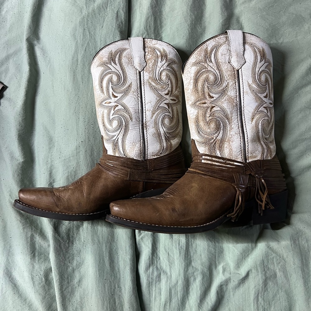 Women’s brown and white cowgirl boots.